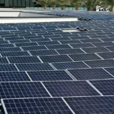 Performing commercial rooftop solar panel cleaning on a large rooftop array in California