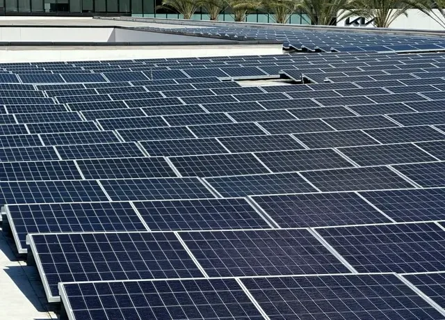 Performing commercial rooftop solar panel cleaning on a large rooftop array in California