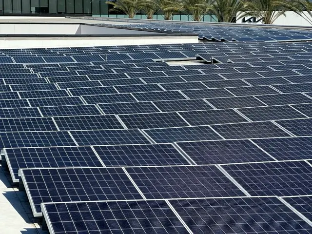 Performing commercial rooftop solar panel cleaning on a large rooftop array in California
