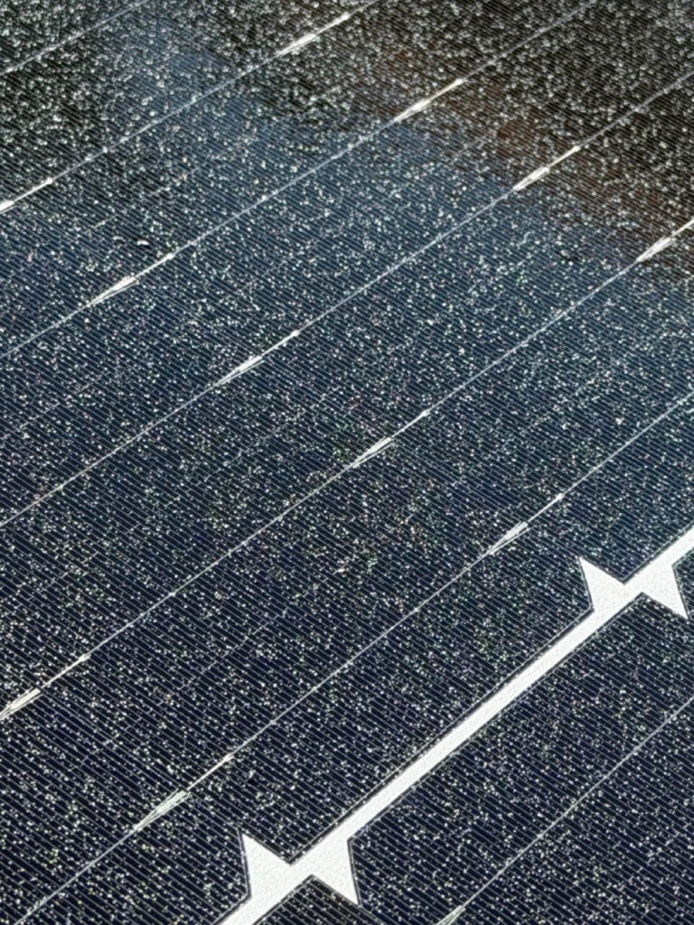 Paint overspray on solar panels requiring professional removal