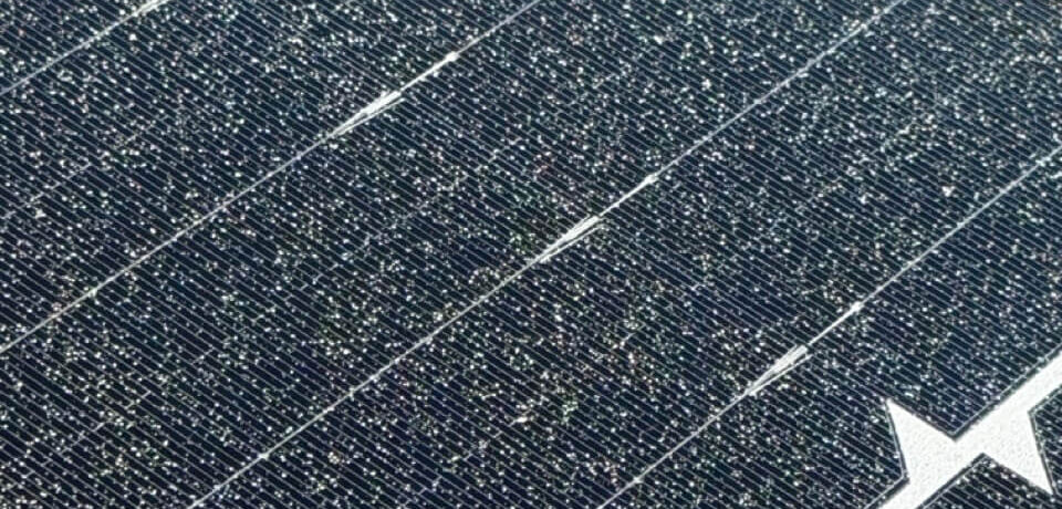 Paint overspray on solar panels requiring professional removal