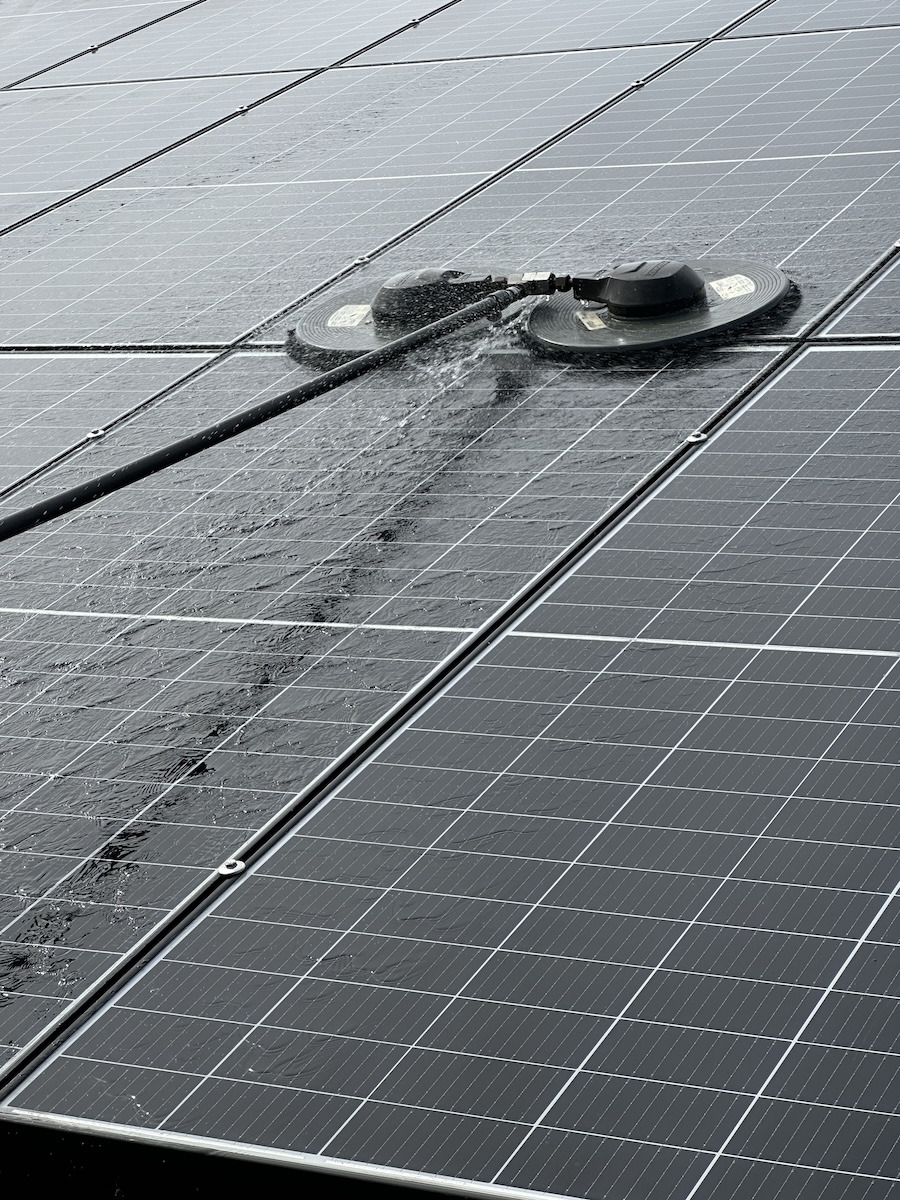 Professional rotating brush equipment used for solar panel cleaning to remove meaningful buildup from panel glass