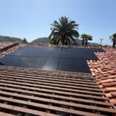 Residential rooftop solar panels on a clay tile roof in Escondido California before professional solar panel cleaning