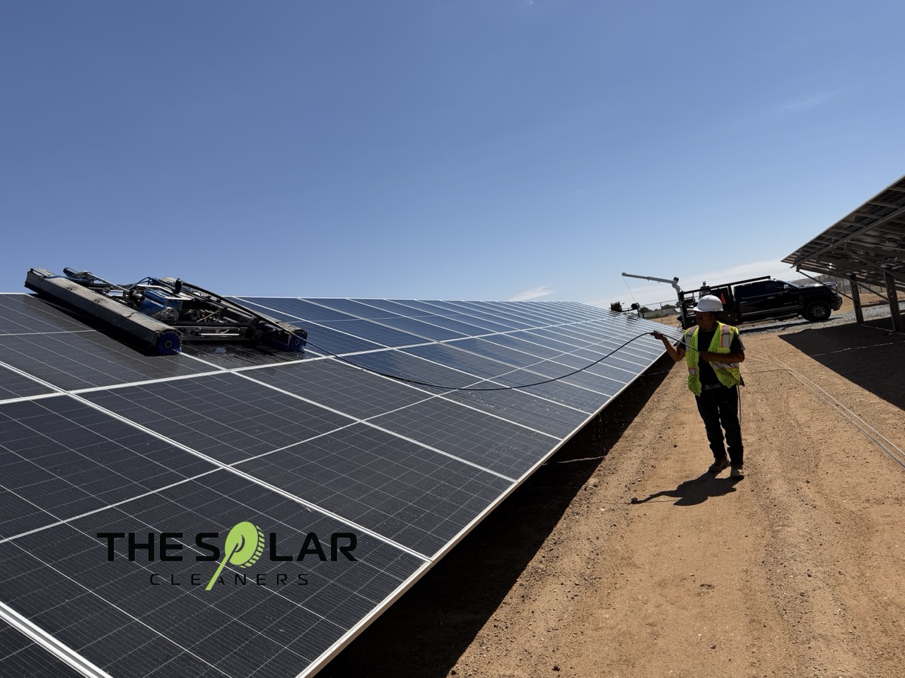 Utility scale solar cleaning with professional solar panel cleaning equipment on a large ground mounted solar array